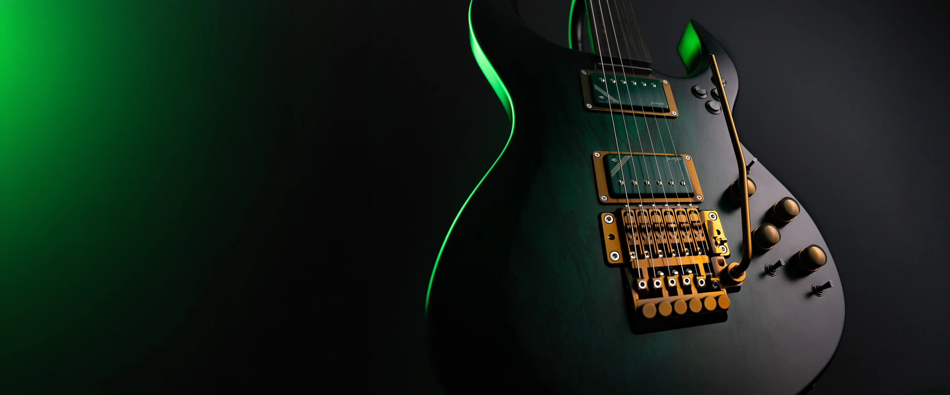 Shark guitar in green studio light with gold hardware