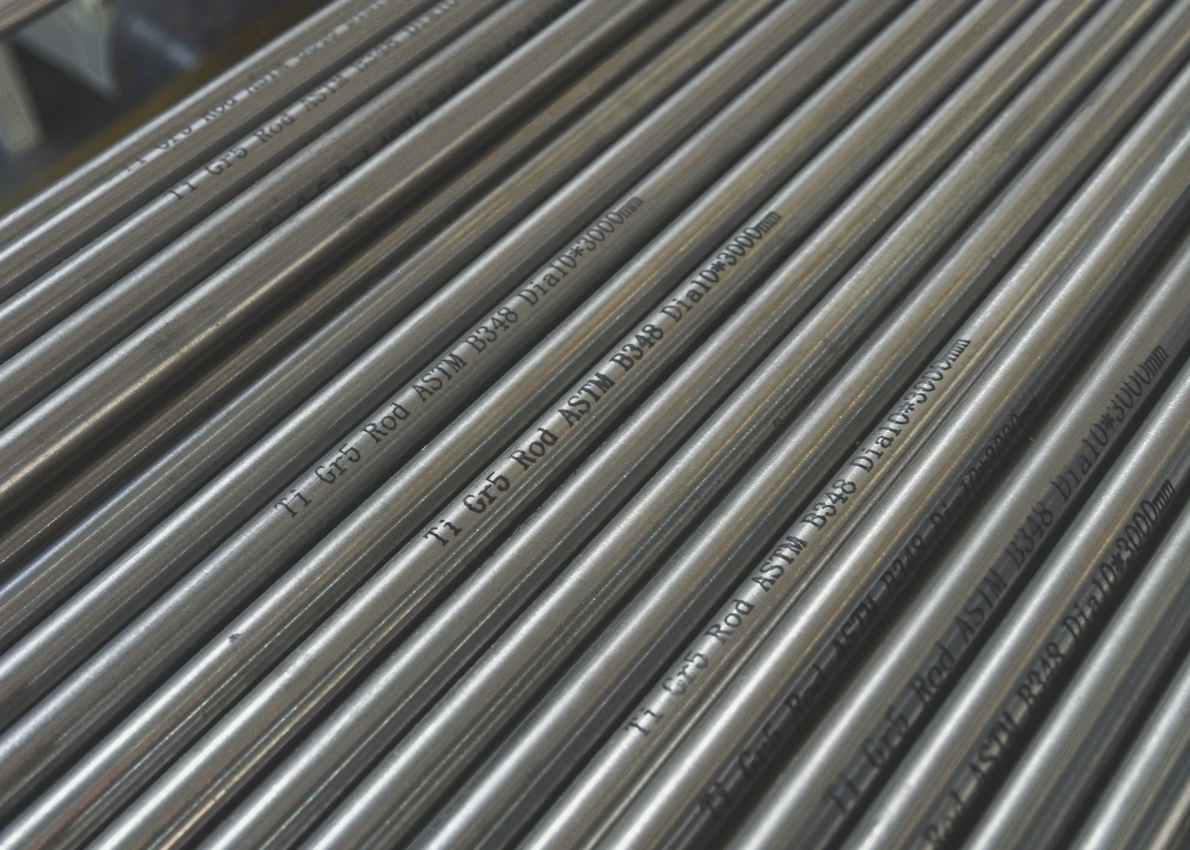 Grade 5 titanium rods close-up with ASTM markings