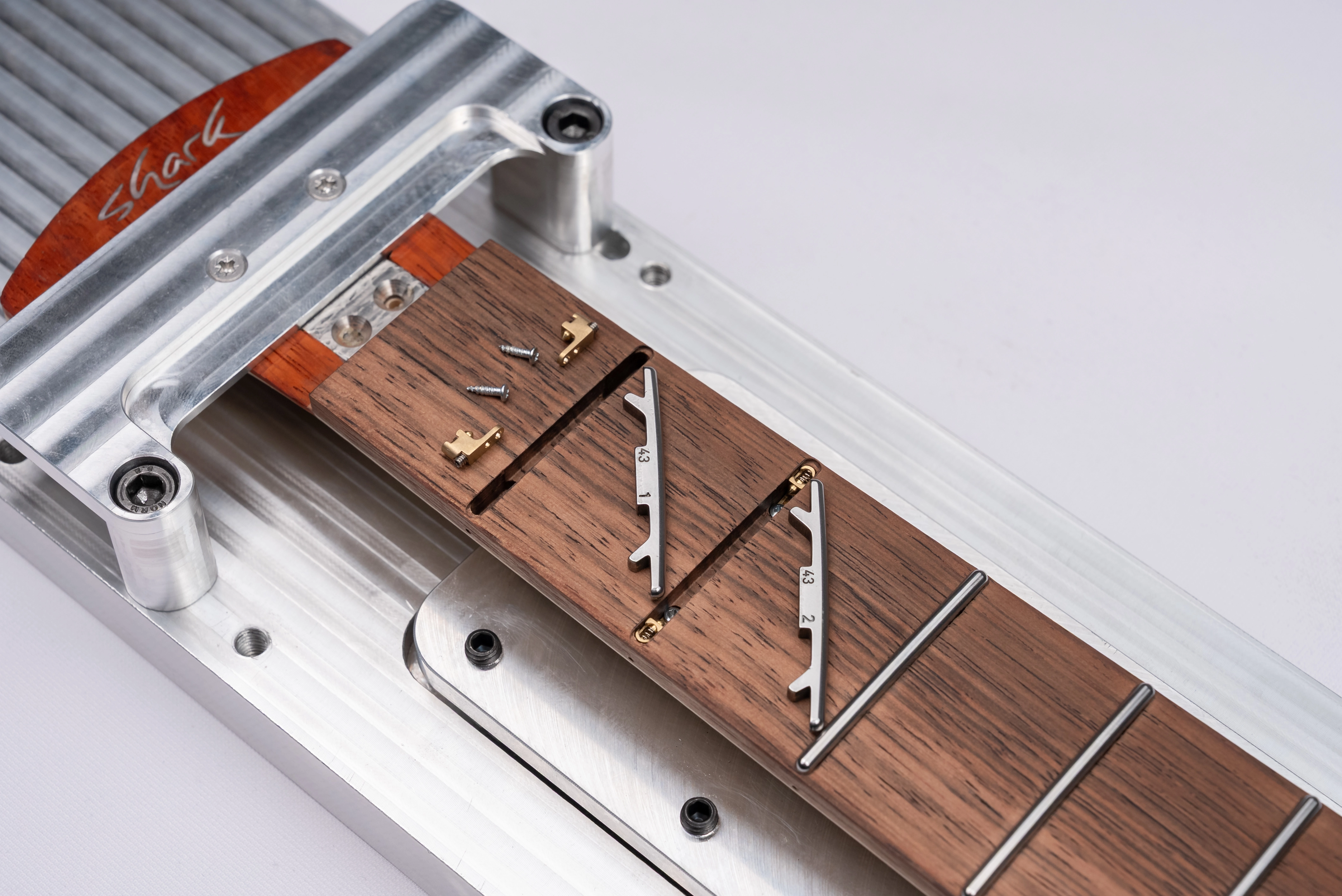 Brass adapters in fretboard channels - angle view